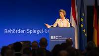 Von der Leyen speaks at desk