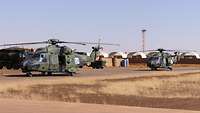 Two NH-90 helicopters parking at Camp Castor in Mali