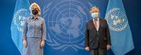 Minister Lambrecht and Antonio Guterres stand side by side in front of the UN logo and flags.