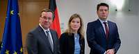 Minister Pistorius Siemtje Möller and Thomas Hitschler, stand side by side in front of the federal service and European flags