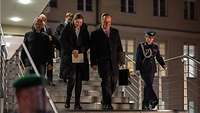 Dovilė Šakalien and Boris Pistorius are walking down steps of the ministry of defence.